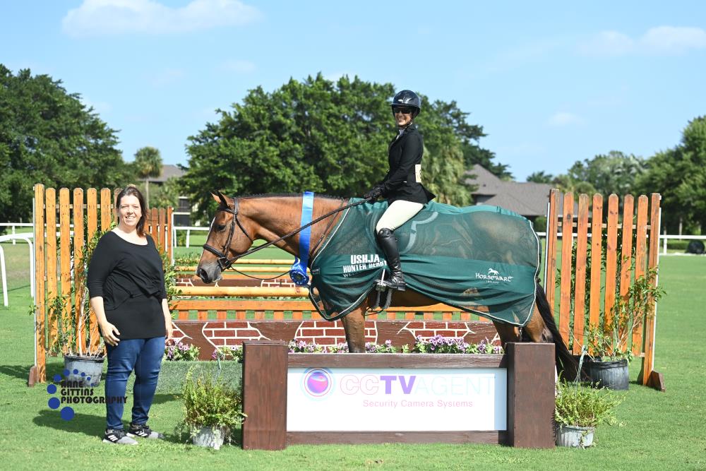 Vivianne Kassin and California Blue, pictured with Tatiana Yaques, CEO of CCTV Agent, won the $2,500 USHJA National Hunter Derby, presented by CCTV Agent. ©Anne Gittins Photography