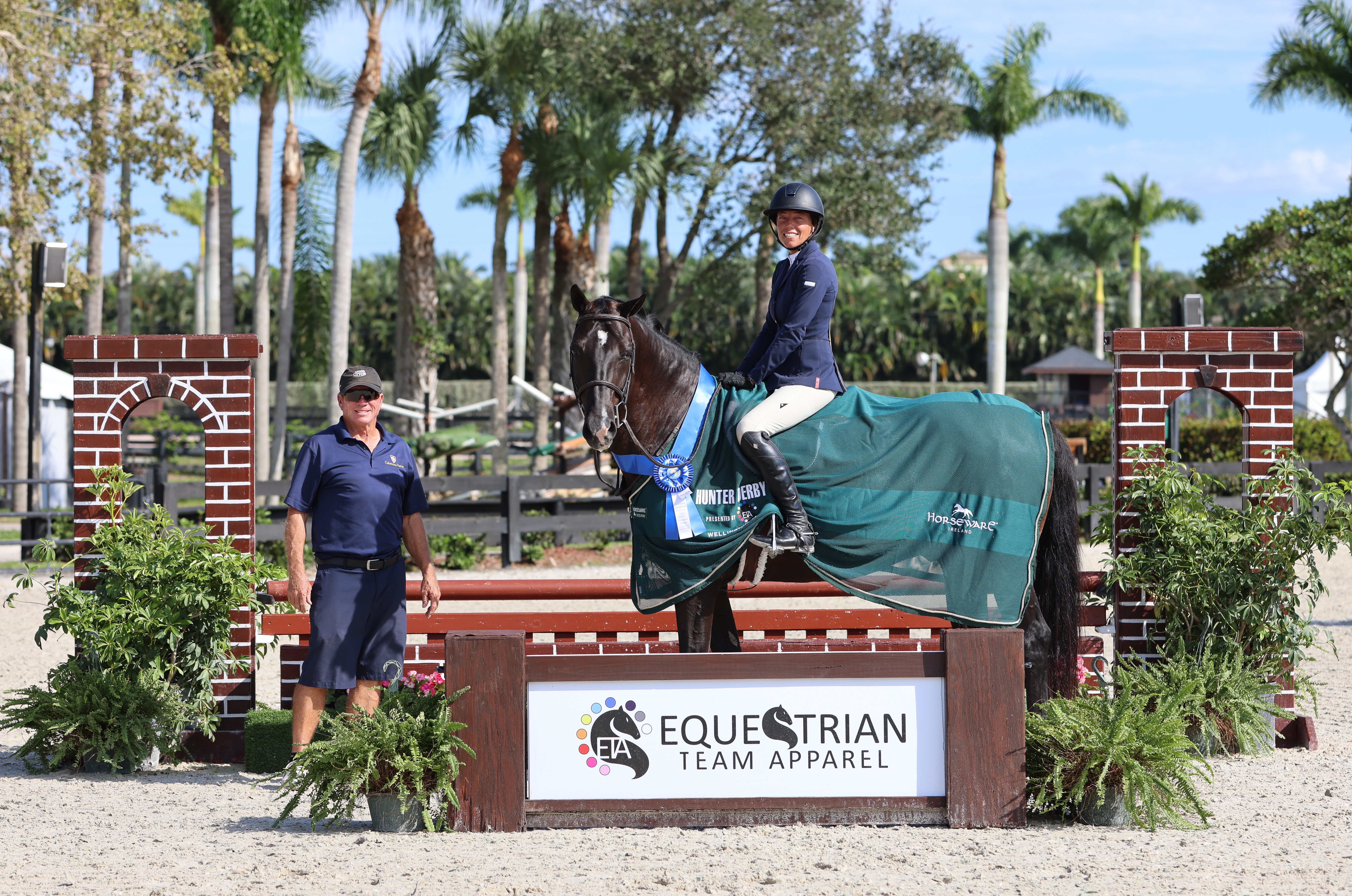 Kim Farlinger and Le Chat Noir, pictured with Tommy Skiffington of Catomine Farm, won the $1,000 Equestrian Team Apparel 2'6"/2"9' Hunter Derby. ©Carly Nasznic Photography 