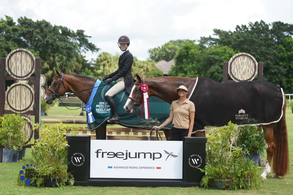 Danielle Menker and Sedrick, pictured with Erika Sergent holding Belino 8, won the $2,500 USHJA National Hunter Derby presented by Freejump. ©Anne Gittins Photography