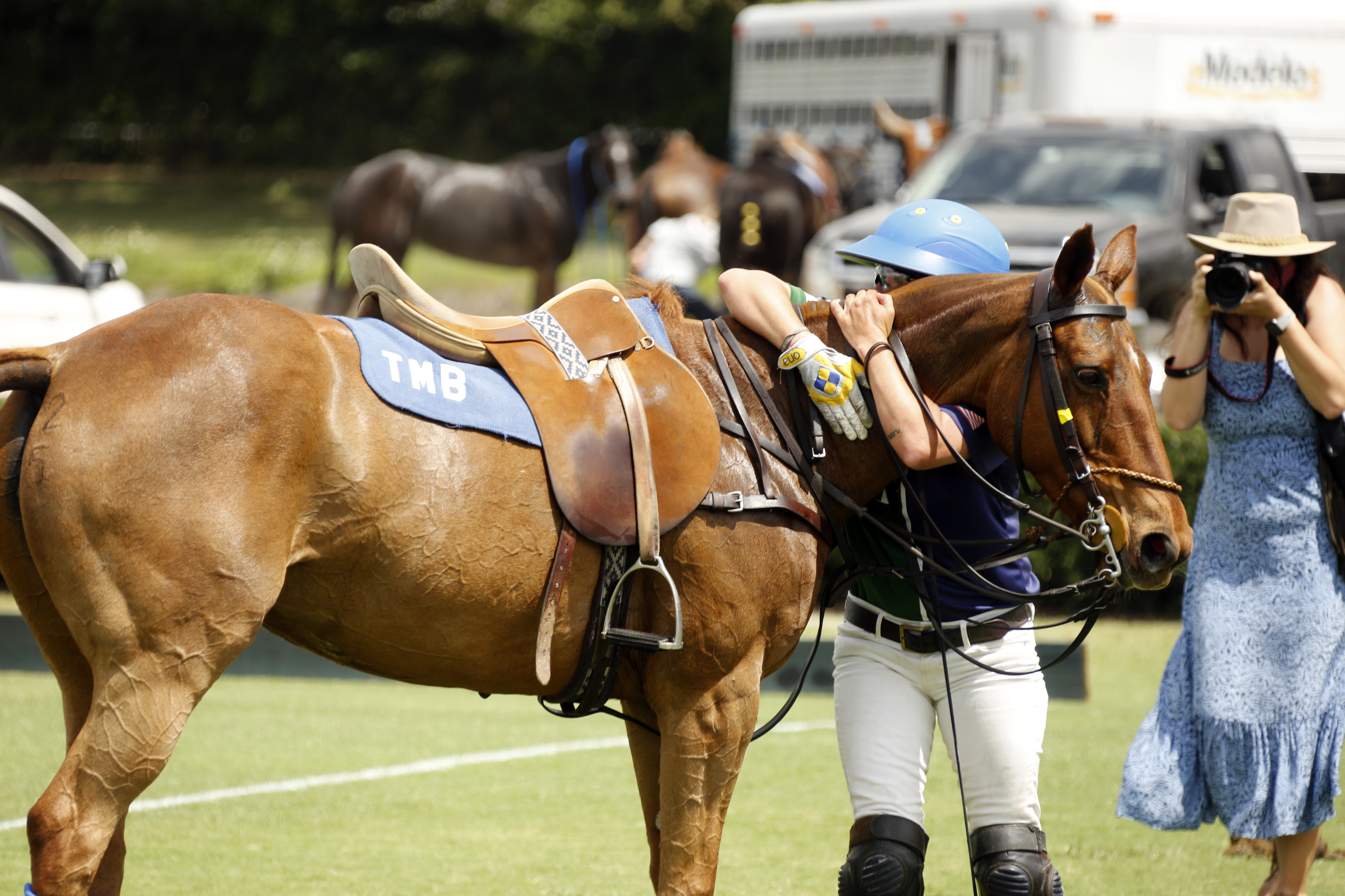 BTA The Villages' Tiffany Busch hugging and celebrating a BTA The Villages victory with all four players riding their own horses. ©David Lominska