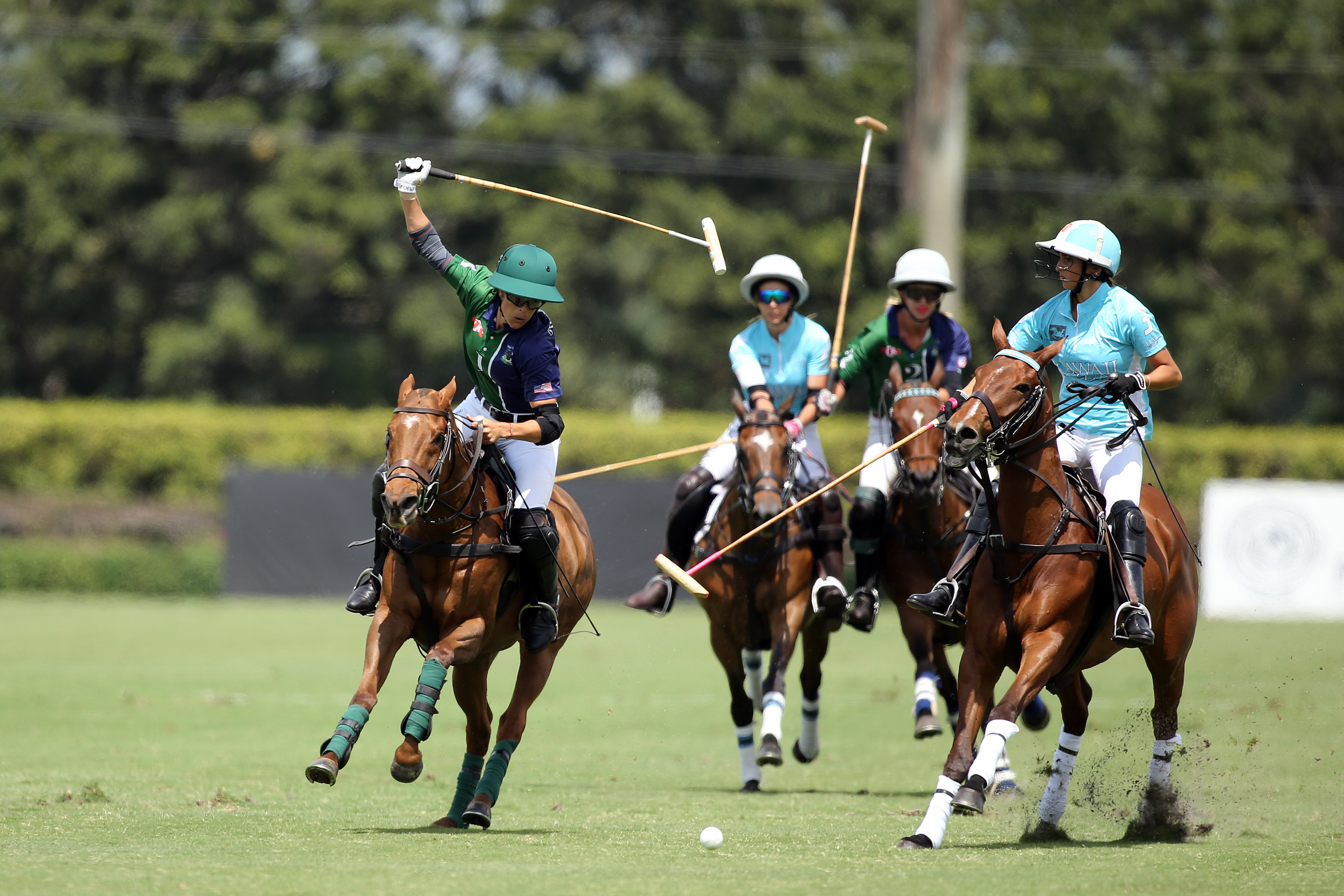 BTA The Villages' Paige Boone hitting the nearside backhand under pressure from Hawaii Polo Life's Mia Cambiaso. ©David Lominska